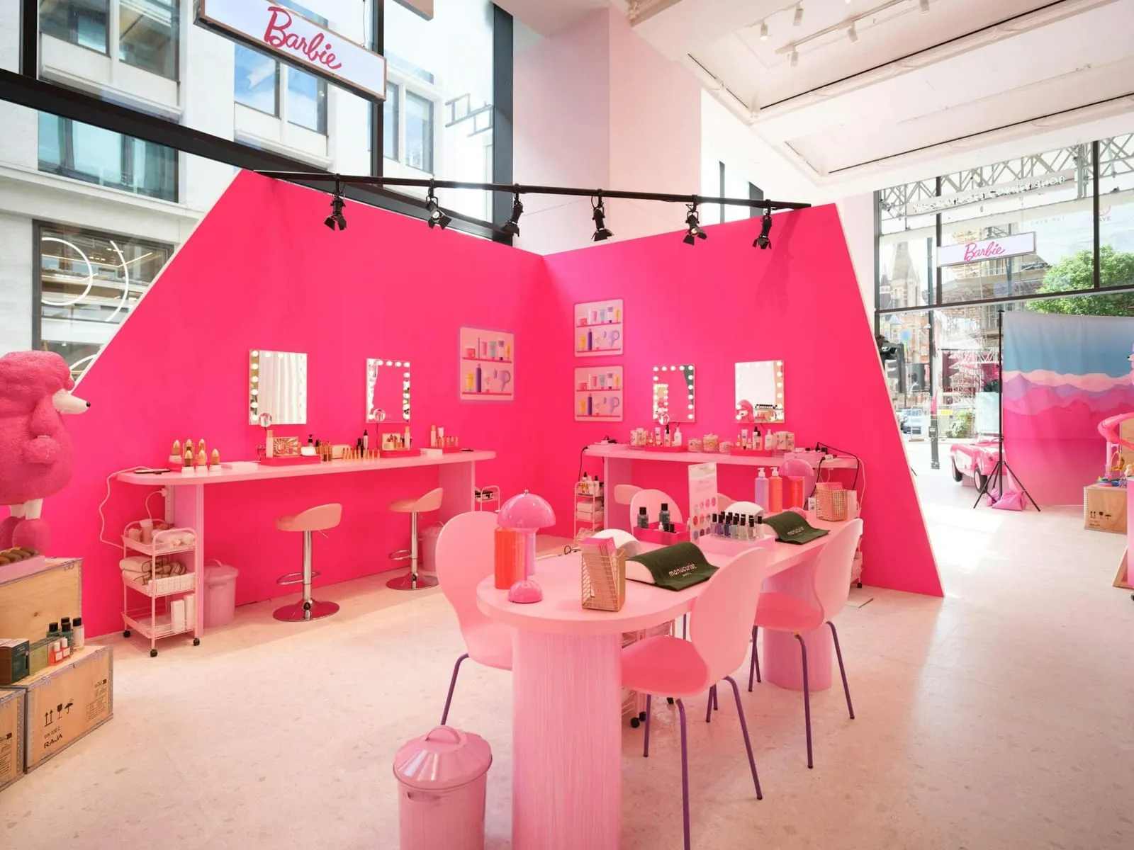 Hot pink Barbie pop-up beauty salon with lit vanity mirrors and manicure tables