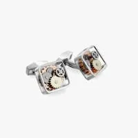 Square gunmetal cufflinks with exposed watch gears visible behind the glass face