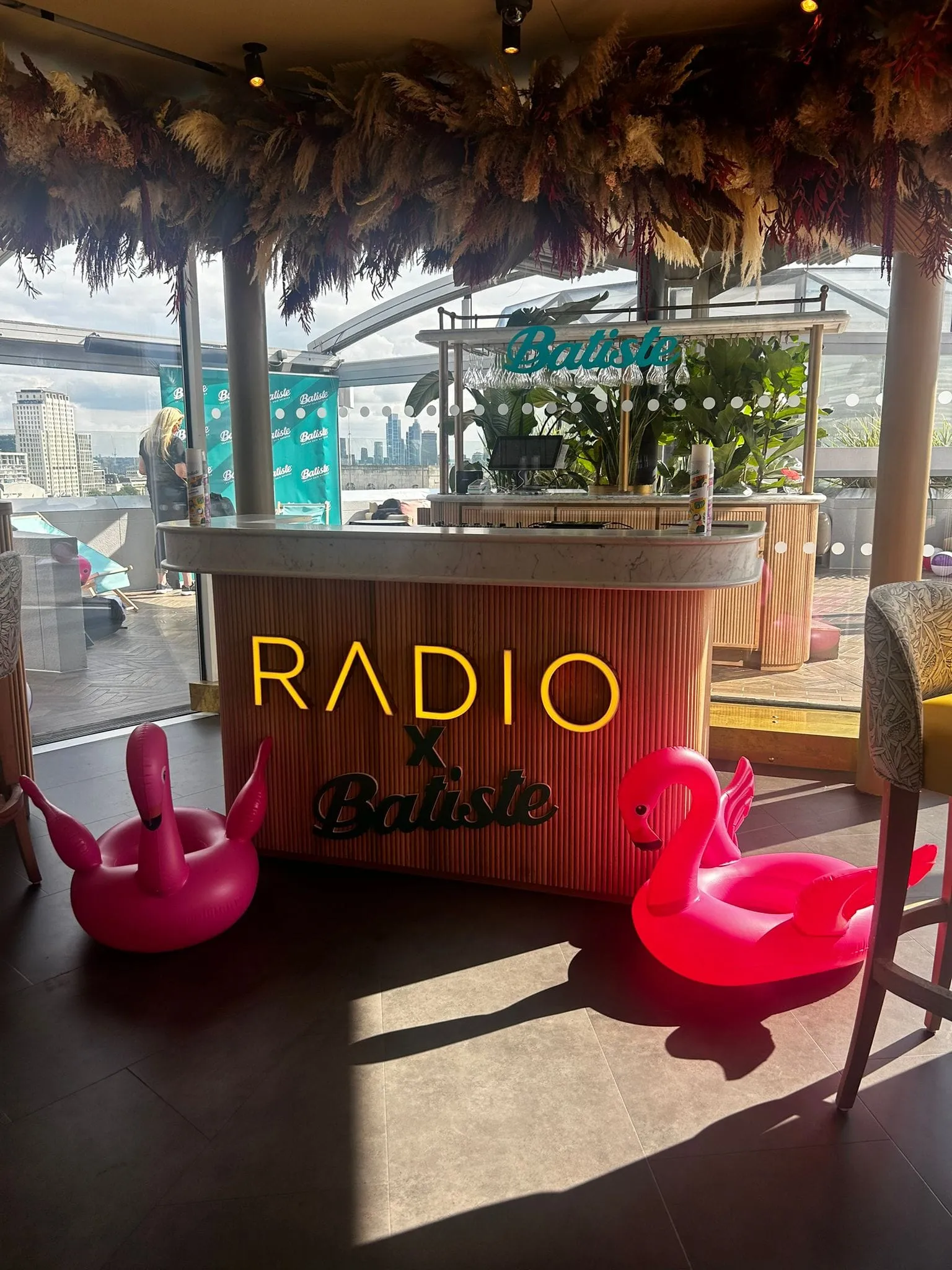 Radio X and Batiste branded bar on a London rooftop terrace with pink inflatable flamingos