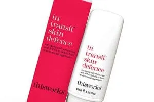 This Works In Transit Skin Defence moisturiser bottle standing beside its pink carton