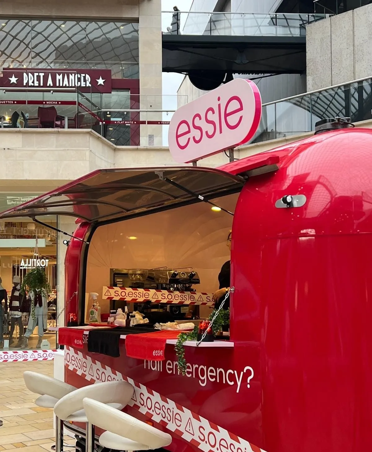 Red essie nail emergency trailer parked inside a shopping centre