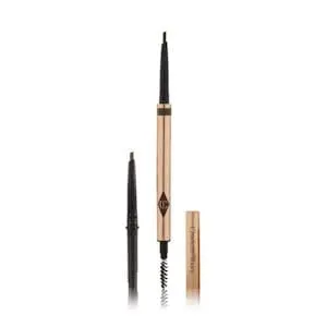 Charlotte Tilbury gold brow pencil, uncapped to show the fine tip and spoolie brush