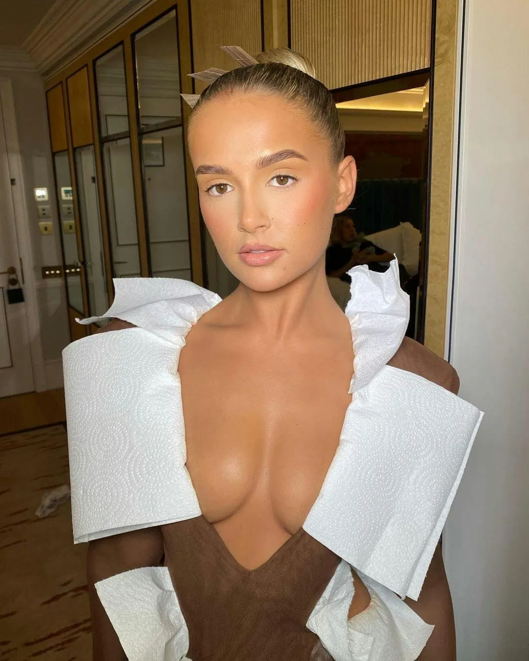Fresh no make-up make-up look with dewy skin and hair slicked back into a bun