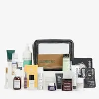 Grooming gift set with a clear zip pouch surrounded by skincare and haircare products